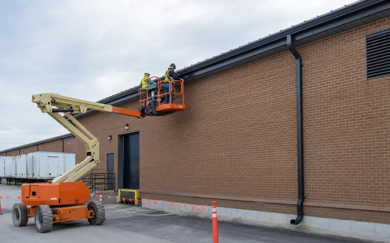 Commercial gutter work coordinated from an elevated platform