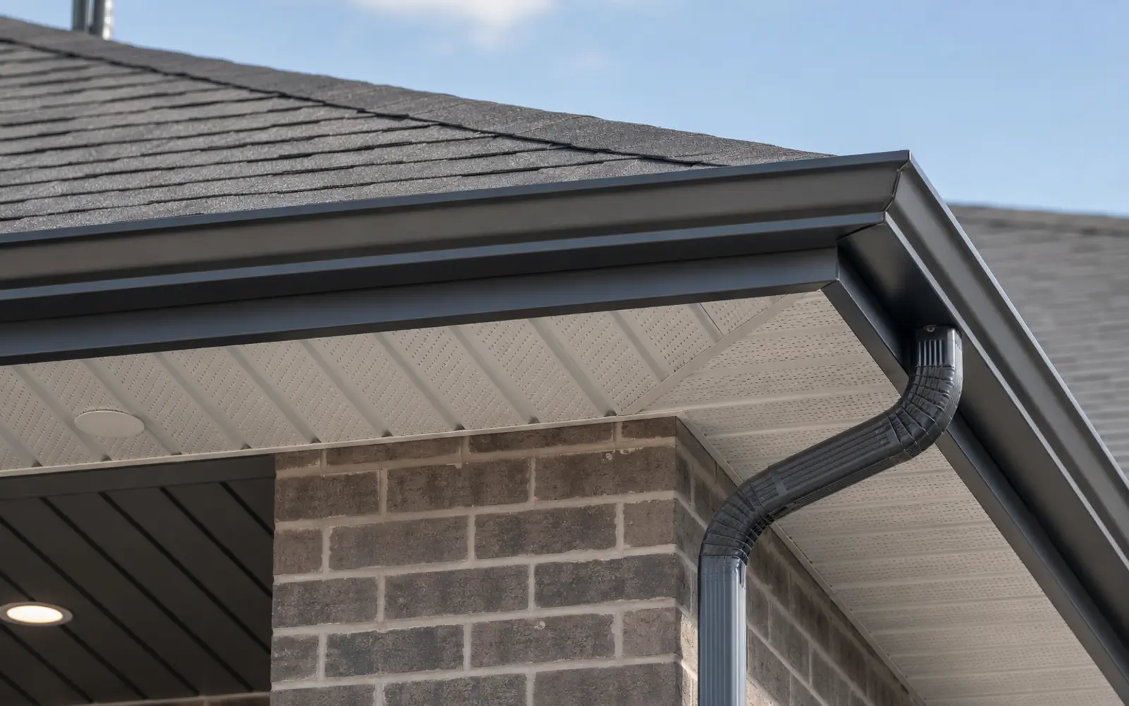 Dark aluminum roofline capping coordinated with soffit and gutters