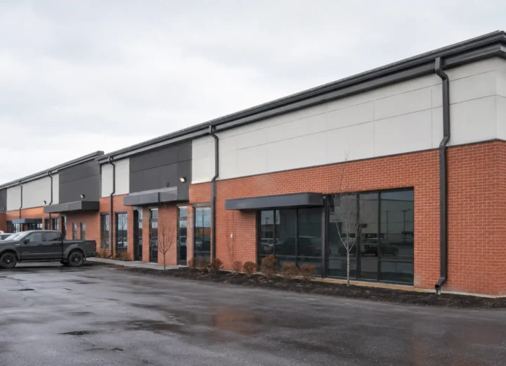 Low-rise commercial plaza with visible exterior gutters and downspouts
